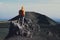 Male hiker looking at recent volcanic crater in Etna Park