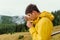 Male hiker in the mountains on a hike eats vermicelli soup on a background of foggy views of the forest