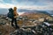 Male hiker overlooking epic view of vast arctic landscape of Stora Sjofallet National Park, Sweden, on autumn day