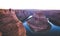 Male hiker overlooking Horseshoe Bend at sunset, Arizona, USA