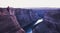 Male hiker overlooking Horseshoe Bend in twilight, Arizona, USA