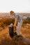 A male hiker packing his backpack and looking involved