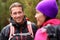 Male hiker portrait in forest talking with woman