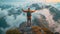 Male hiker reaches spot raising arms up overlooking beautiful mountain landscape. Traveler standing on rock looking at