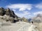 Male hiker on a rocky and dusty hiking trail in the French Alps