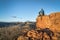 Male hiker sitting on a top of sandstone rock formation