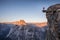 Male hiker standing on overhanging rock at Glacier Point, Yosemite National Park, California, USA