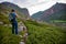 Male hiker takes photo of beautiful mountains and ancient tombs. North Caucasus