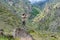 Male hiker takes photo of beautiful mountains in North Caucasus in summer