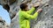 Male hiker tying a rope of hammock on a rock 4k