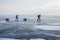 male hikers with backpacks walking on ice water surface during daytime,,russia, lake