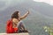 Male hipster traveler doing selfie on mountains background