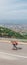 Male hipster wearing a hat and a red shirt is riding a longboard downhill on an open road