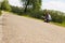 Male hitchhiker is sitting on a street