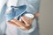 male is holding a pair of blue newborn shoes in his hand close up