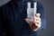 Male holds glass of water with dissolved pill