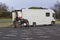 A male horse handler leads a yonng mare into a large horse into a transporter after a morning trekking in Tollymore Fores Park