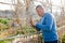 Male horticulturist working with wooden girders in garden