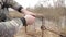 A male hunter sets a metal trap for a beaver. Beaver hunting in a trap on the river bank. Beaver hunting with a trap.