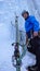 Male ice climber at a belay stance in a steep ice fall in the Alps