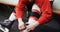 Male ice hockey player tying skate in dressing room 4k