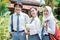 male Indonesian high school student and two female high school students wearing a school bag and smiling