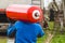 A male industrial worker walks with a gas cylinder to a gas car. Transportation and installation of a propane bottle to