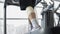 Male with injured leg muscle walking on treadmill in gym, recovery, will power