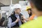 Male inspector having discussion with worker in metal industry