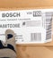 Male installer hand pointing to a cardboard box of Bosch Dishwasher