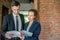 Male investor in a black suit reading the contract