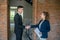 Male investor in a black suit shaking hands with the broker