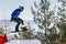 male italian snowboarders jumping drops in snowboarding competition