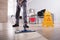 Male Janitor Cleaning Floor In Office