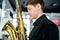 Male jazz musician playing a saxophone in a restaurant