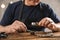 Male jeweler evaluating necklace at table in workshop