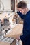 Male joiner adjusting chipboard at workshop