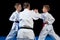 Male karate instructor training little children in dojo