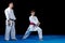 Male karate instructor training little children in dojo