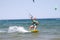 A male kite surfer rides the waves