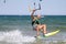 A male kite surfer rides the waves