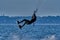 A male kiteboarder rides on a board on a large river.