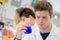 Male laboratory student checking flask