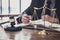 Male lawyer or judge working with contract papers, Law books and wooden gavel on table in courtroom, Justice lawyers at law firm,