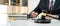 A male lawyer or notary working with contract papers, book and wooden gavel on table in courtroom, Law and Legal services concept