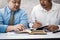 Male lawyer teaching new lawyer and  discussing with contract papers and wooden gavel on table in courtroom. justice and law ,