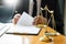 Male lawyer working with contract papers and reading law book in a courtroom, justice and law concept while presiding over trial