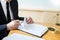 Male lawyer working with contract papers and reading law book in a courtroom, justice and law concept while presiding over trial