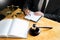 Male lawyer working with contract papers and reading law book in a courtroom, justice and law concept while presiding over trial