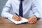 Male lawyer working with documents at table, closeup.